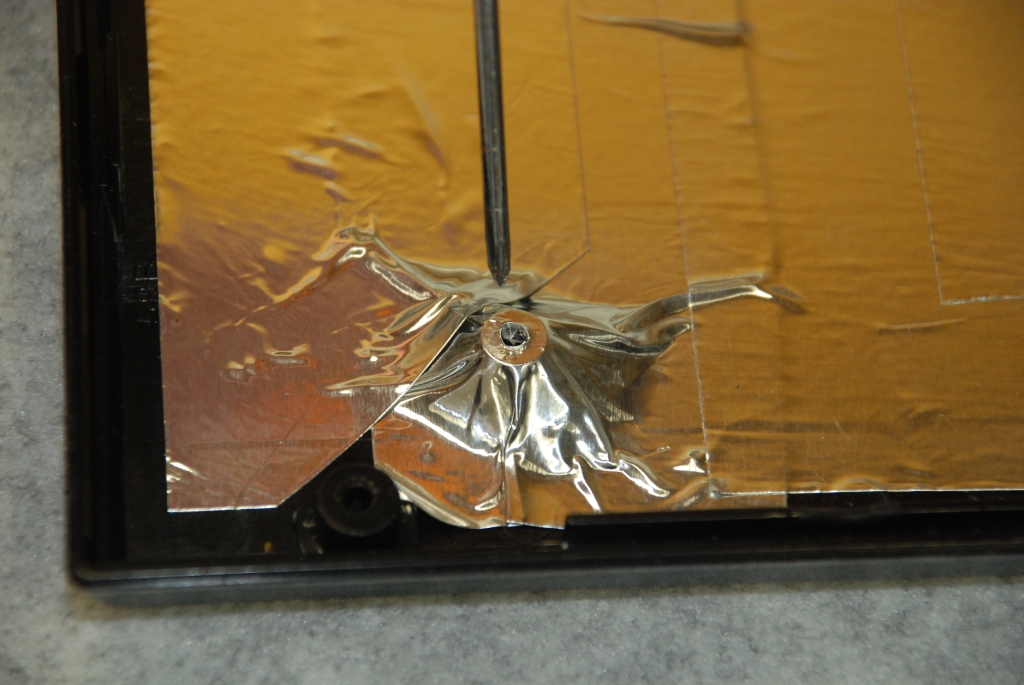 Perforating the foil at the bosses.